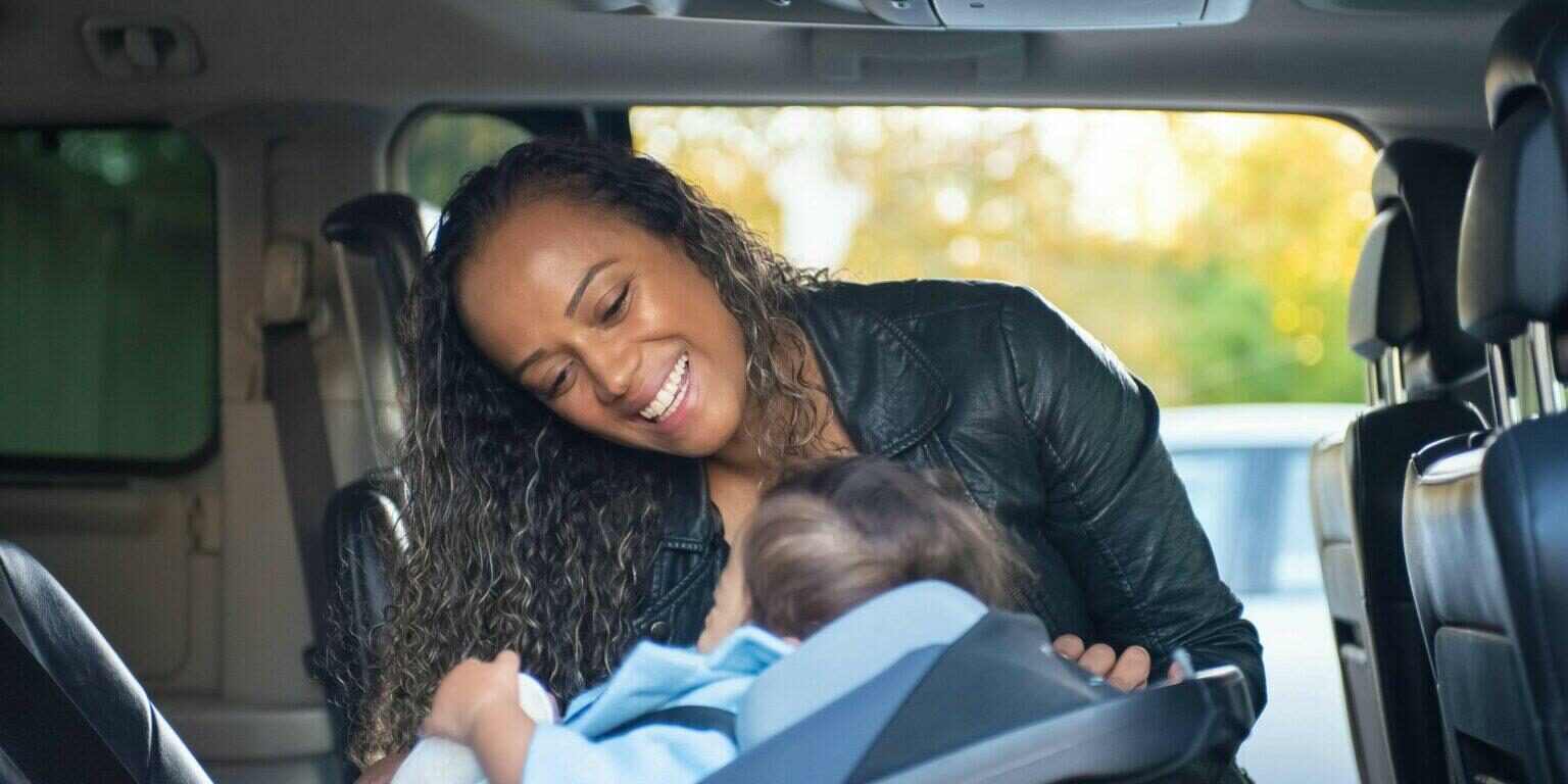https://www.pexels.com/photo/a-woman-looking-at-her-child-on-a-car-seat-6182086/
