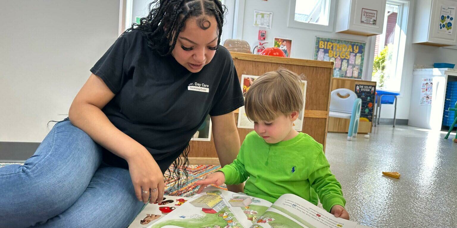 central-falls-dr.day-care-ddc-daycare-teacher-reading-book-toddler